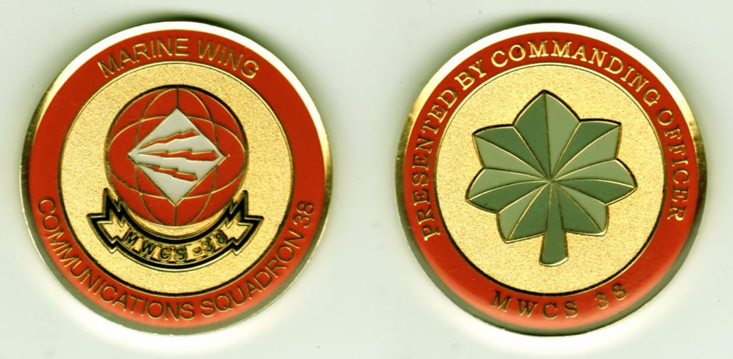 Round shaped, gold colored coin, 1 13/16 inches in diameter.