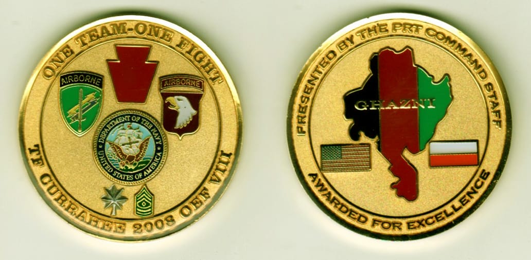 Round shaped, gold colored coin, 1 13/16 inches in diameter.