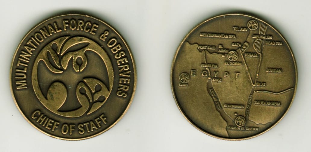 Round shaped, brass colored coin, 1-5/8 inches in diameter.