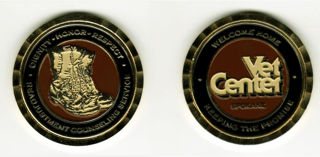 Round shaped, gold colored coin, 1 13/16 inches in diameter.