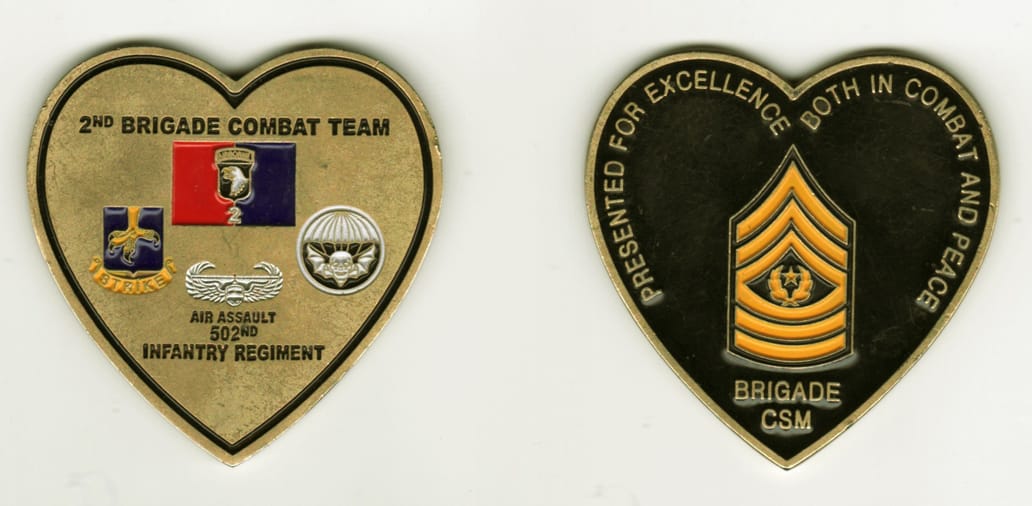 Heart shaped, brass colored coin, 2 1/2 inches wide x 2 1/2 inches high.