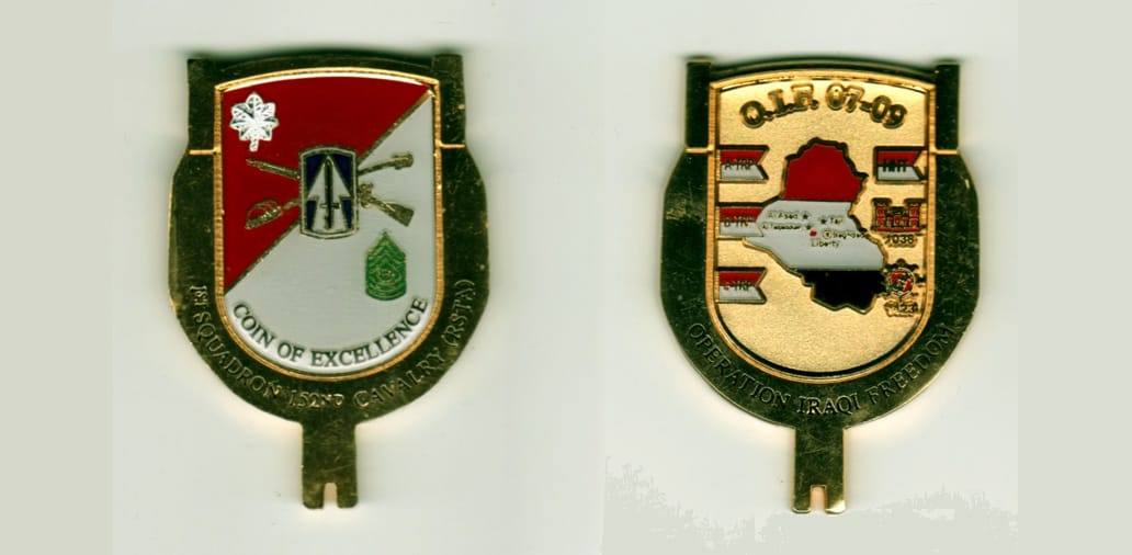 Shield shaped with extended notched key design on bottom, gold colored coin, 1 1/2 inches wide x 2 1/4 inches high.