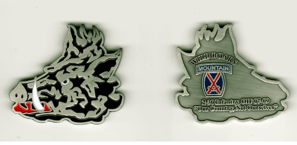 Boar's head  shaped, silver colored coin, 2 inches wide x 1 3/4 inches high.