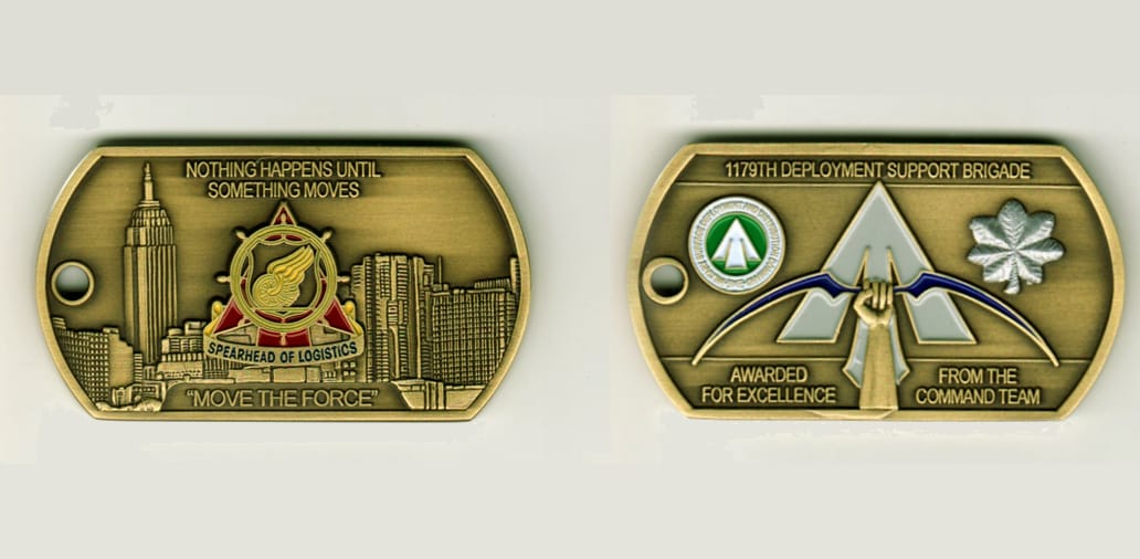 Dog tag shaped, brass colored coin, 2 1/2 inches wide x 1 1/4 inches high.