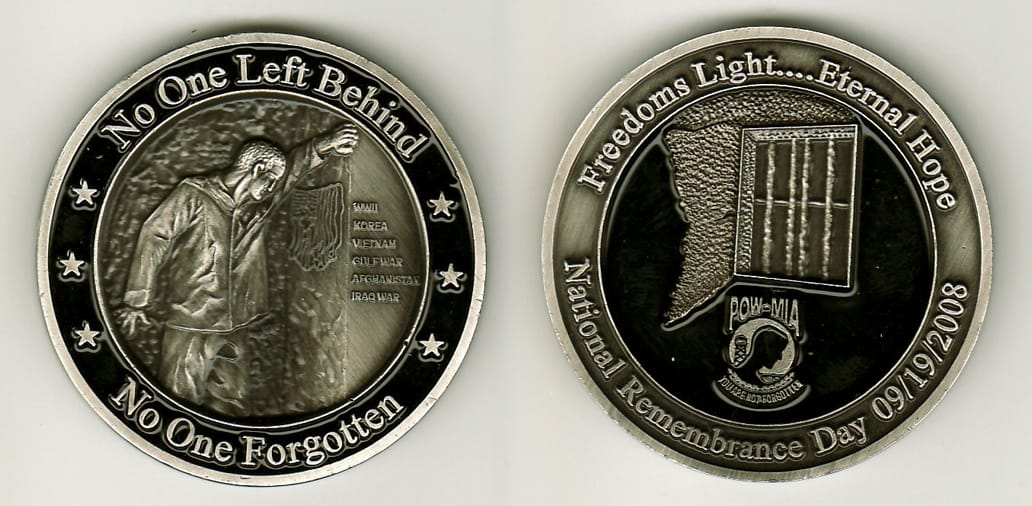 Round shaped, pewter colored coin, 2 1/8 inches in diameter.