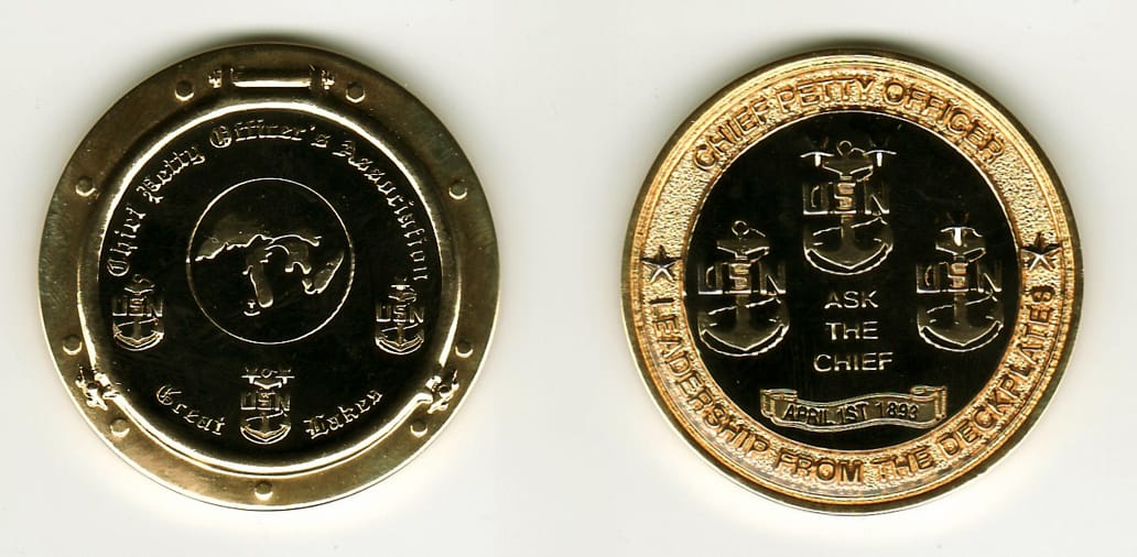 Round shaped, gold colored coin, 1 13/16 inches in diameter.