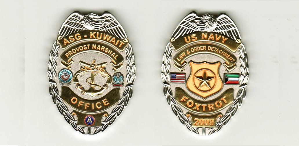 Oval shaped, silver colored police badge styled coin, 1 1/4 inches wide x 2 inches high.