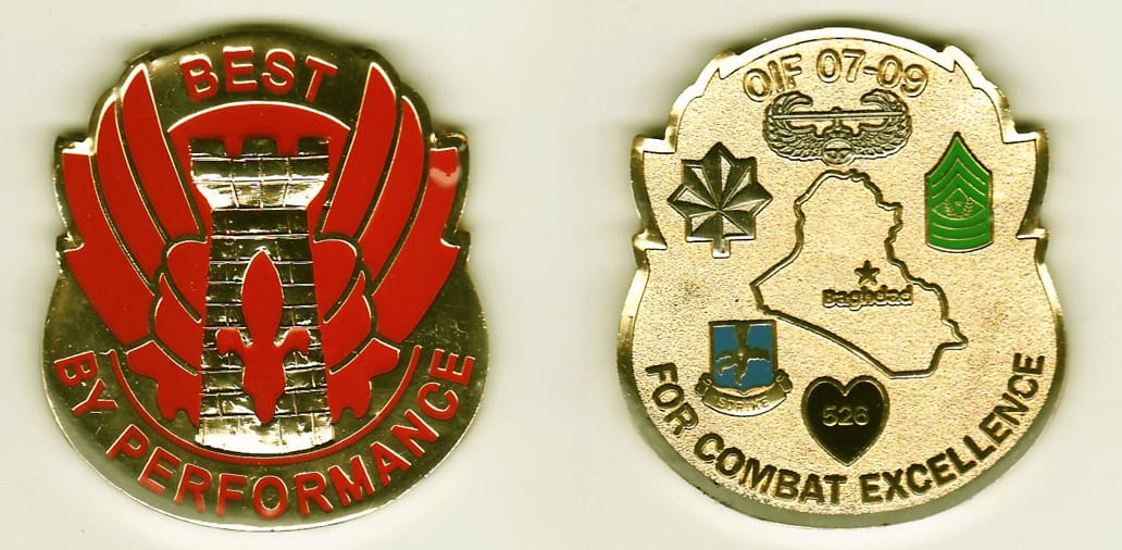 Elongated round  shaped, gold colored coin 1 3/4  inches wide x 2 inches high.