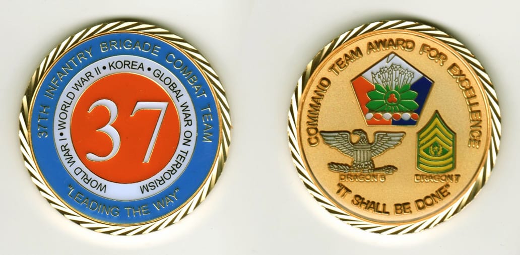 Round shaped, gold colored coin, 2 1/8  inches in diameter.