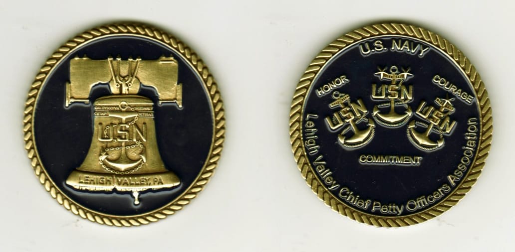 Round shaped, brass colored coin, 1 13/16  inches in diameter.