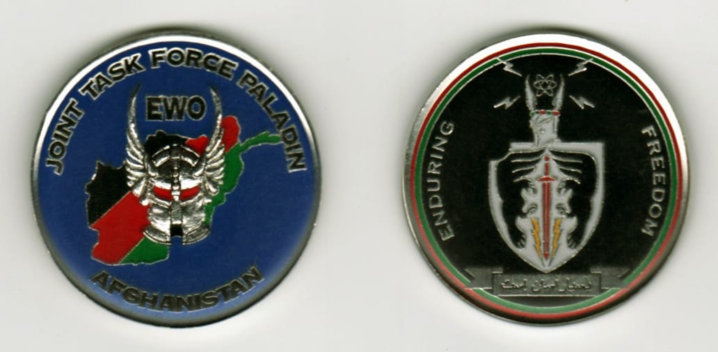 Round shaped, silver colored coin, 1 13/16 inches in diameter.