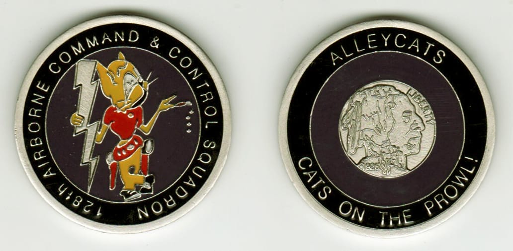 Round shaped, pewter colored coin, 1-5/8  inches in diameter.