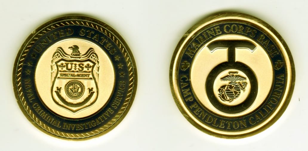 Round shaped, gold colored coin, 1 11/16  inches in diameter.