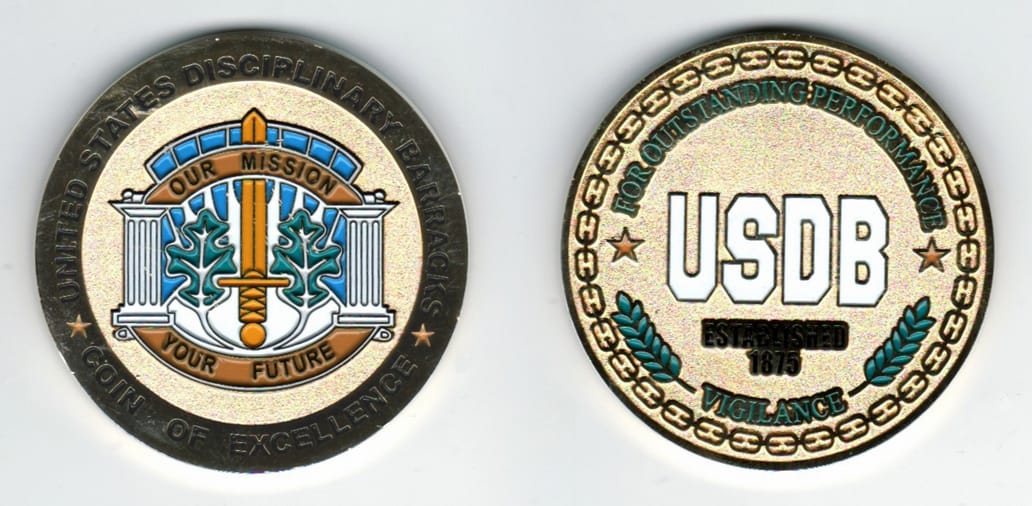 Round shaped, gold colored coin, 2 1/8  inches in diameter.