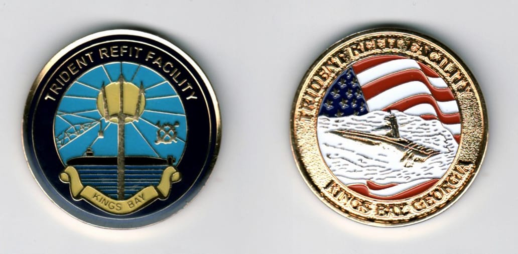 Round shaped, gold colored coin, 1 3/8  inches in diameter.