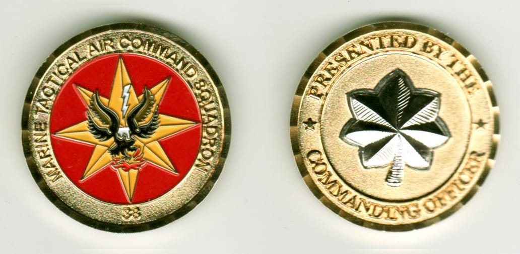 Round shaped, gold colored coin, 1 1/4 inches in diameter.