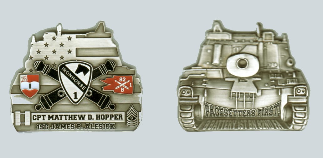 Tank shaped, silver colored coin, 2 inches wide x 1 3/4 inches high.