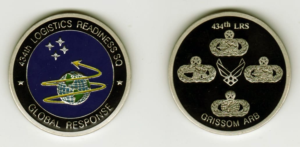 Round shaped, pewter colored coin, 1 1/2 inches in diameter.