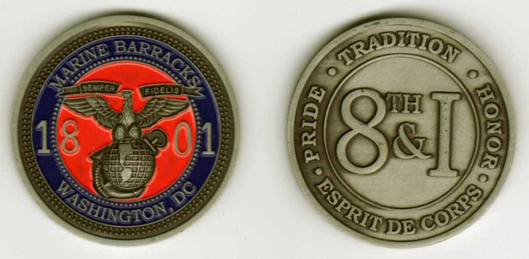 Round shaped, pewter colored coin, 1 11/16 inches in diameter.