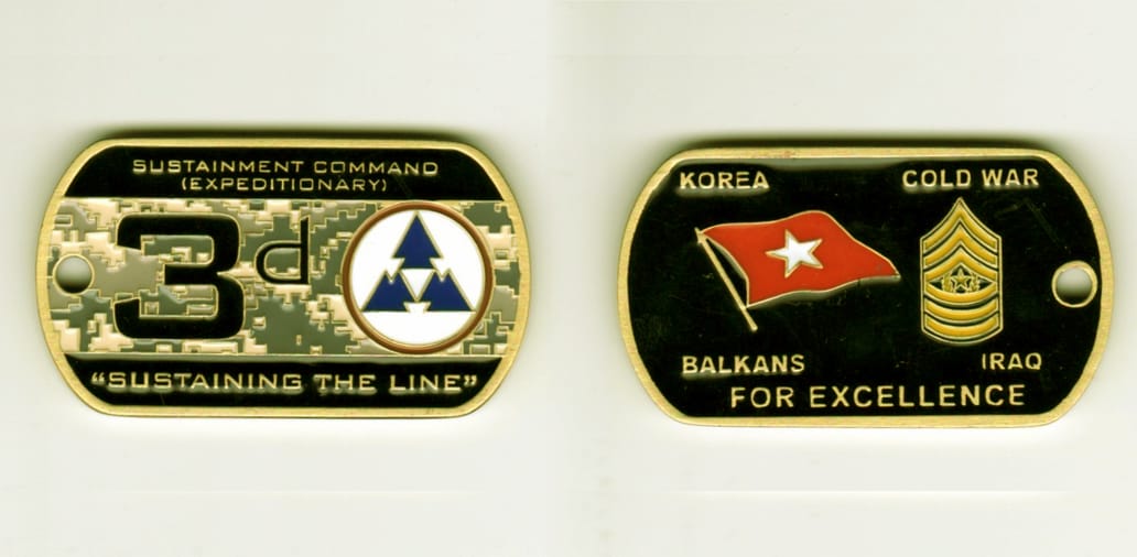 Dogtag shaped, brass colored coin, 1-1/4 inch high x 2 1/4 inches wide.