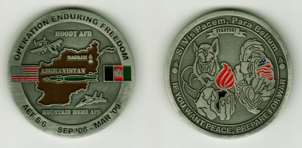 Round shaped, pewter colored coin, 1 11/16  inches in diameter.