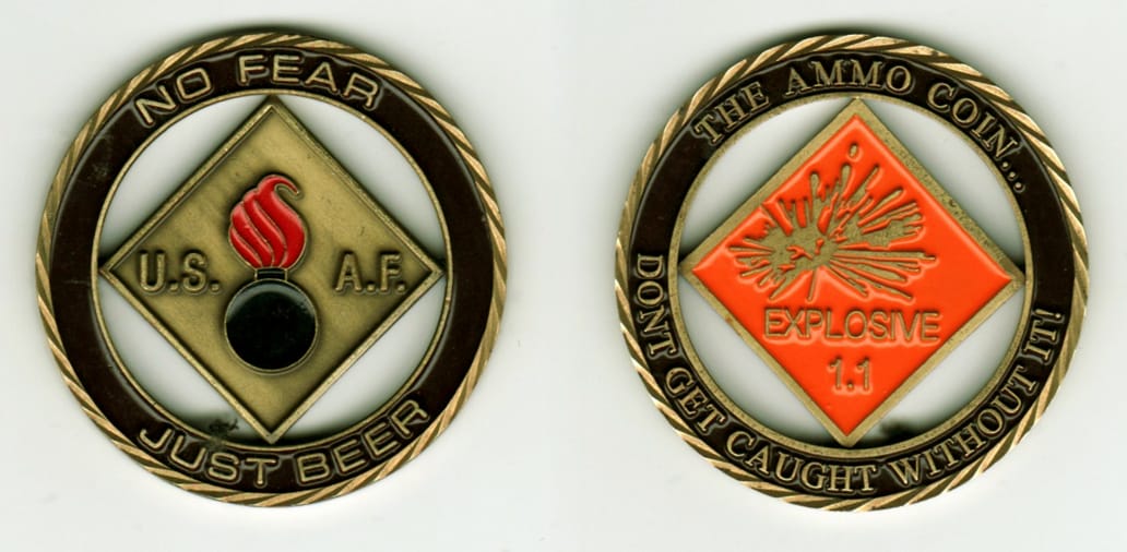 Round shaped, brass colored coin with cut out areas inside, 2 1/8  inches in diameter.