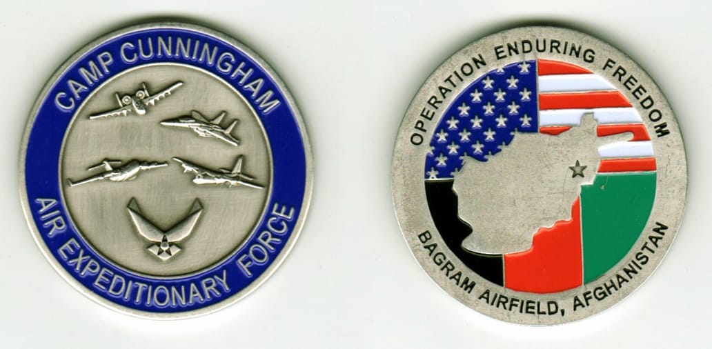 Round shaped, silver colored coin, 1 11/16  inches in diameter.