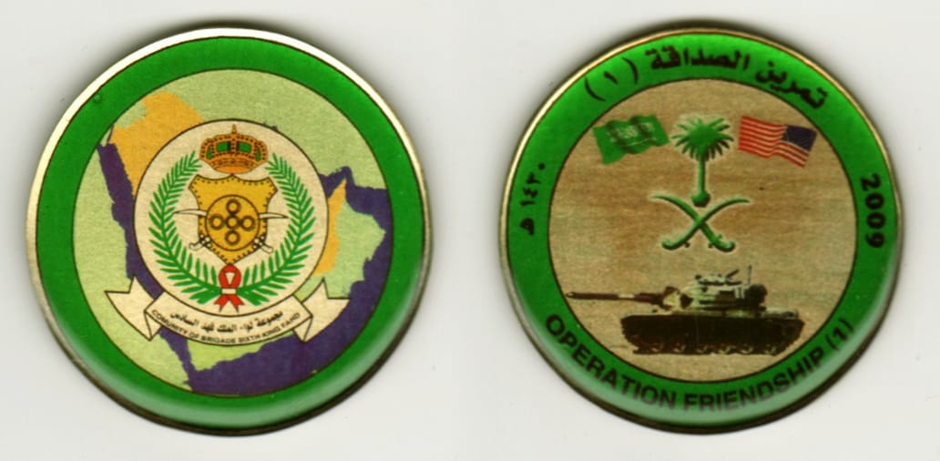 Round shaped, brass colored coin, 1 13/16  inches in diameter.