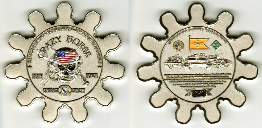 Round  cog shaped, silver colored coin 2- 9/16 inches in diameter.