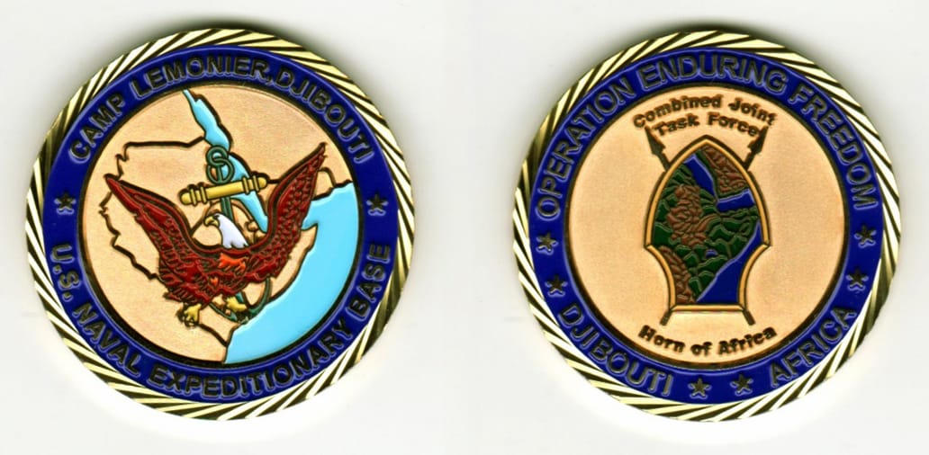 Round shaped, gold colored coin, 1 11/16  inches in diameter.