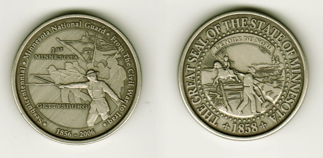 Round shaped, pewter colored coin, 1 1/2  inches in diameter.