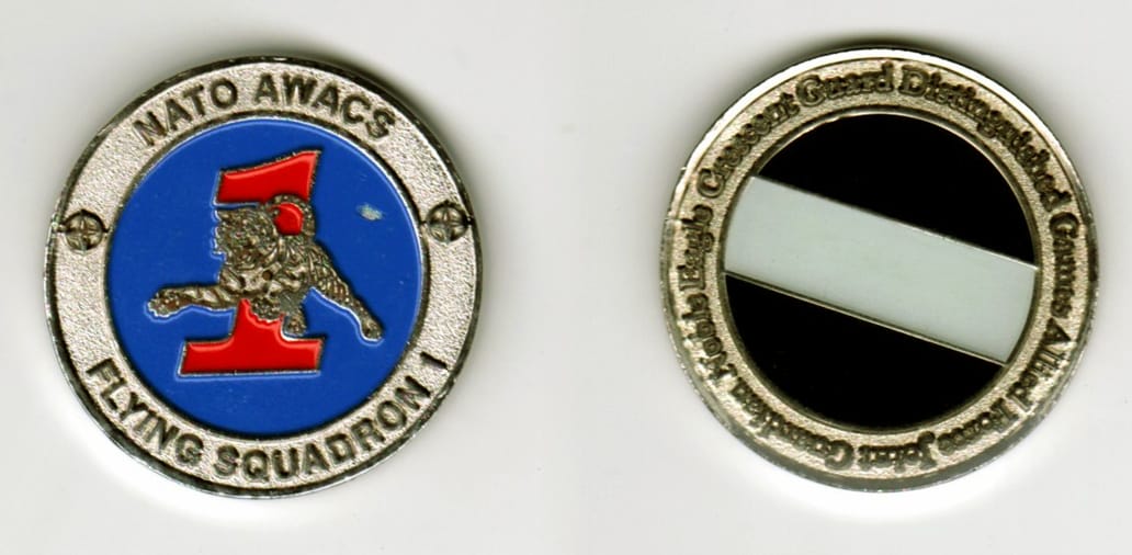 Round shaped, silver colored coin, 1 3/8  inches in diameter.