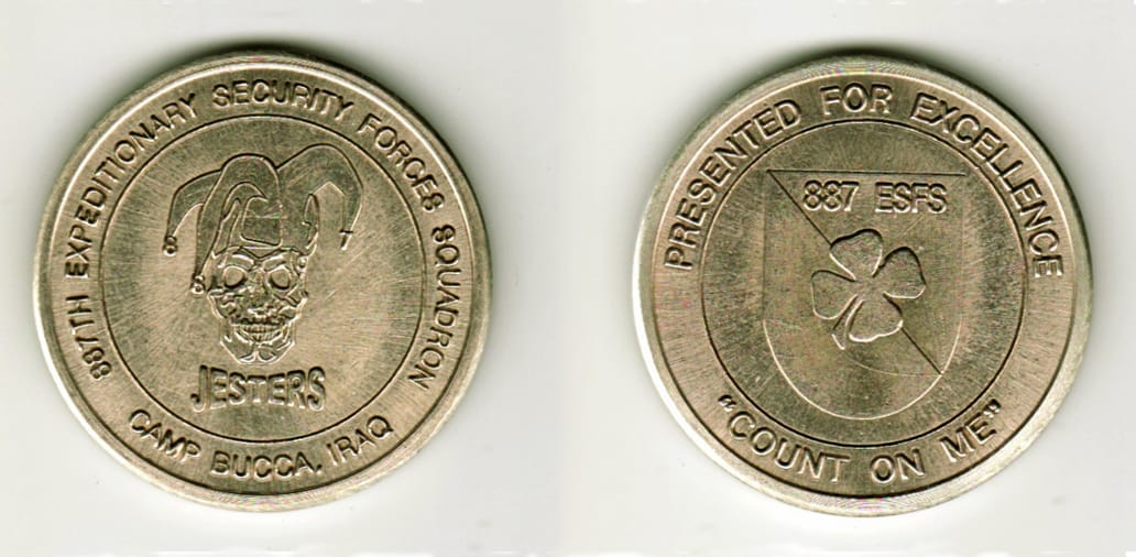 Round shaped, silver colored coin, 1 11/16  inches in diameter.