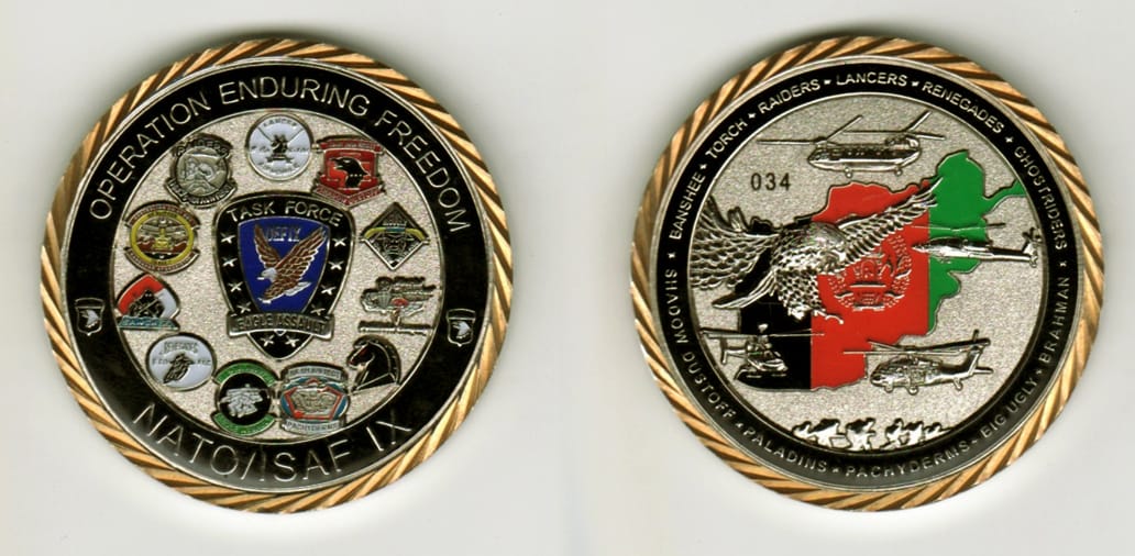 Round shaped, silver colored coin, 2  inches in diameter.