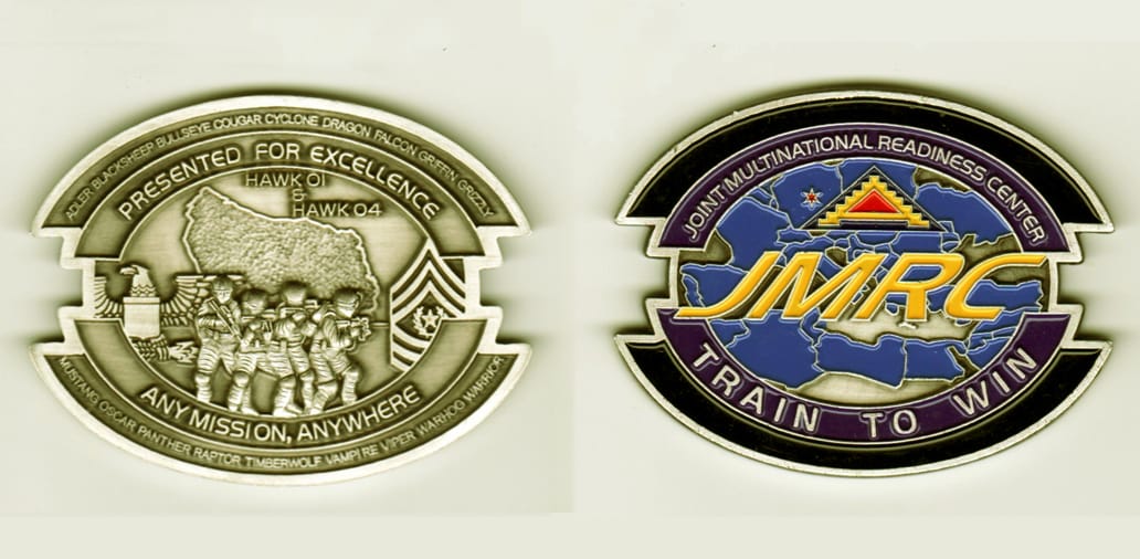 Oval shaped, silver colored coin, 2 3/4 inches wide x 2 inches high.