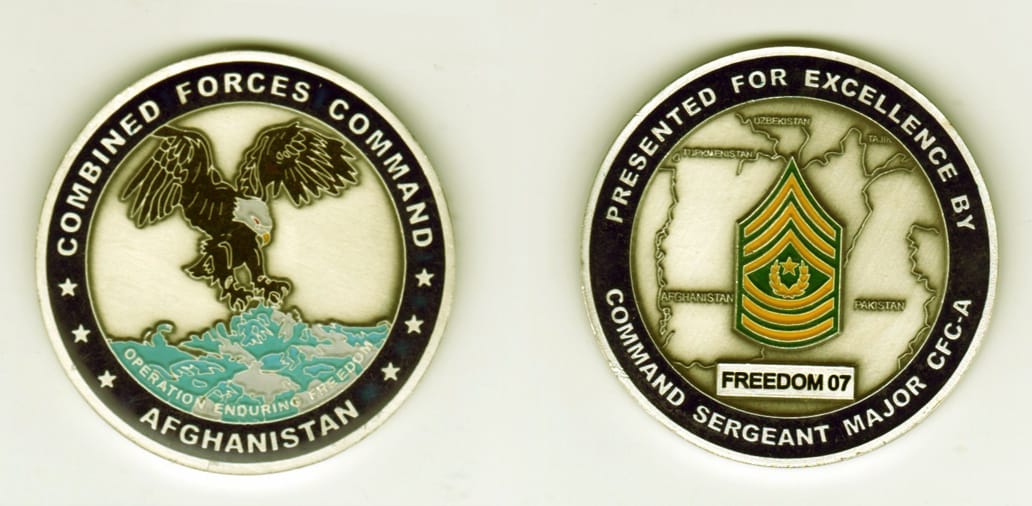 Round shaped, silver colored coin, 2 1/8 inches in diameter.