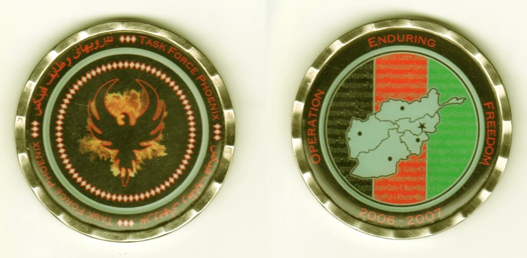 Round shaped, silver colored coin, 2  inches in diameter.