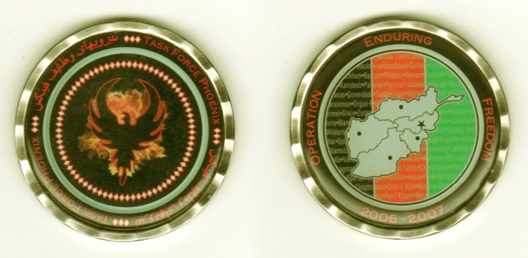 Round shaped, silver colored coin, 2  inches in diameter.