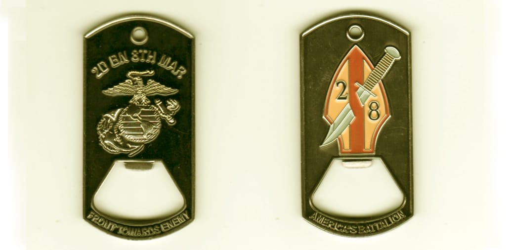 Dog tag shaped with cut out can opener area, brass colored coin, 1 1/2 inches wide x 2 1/2  inches high.