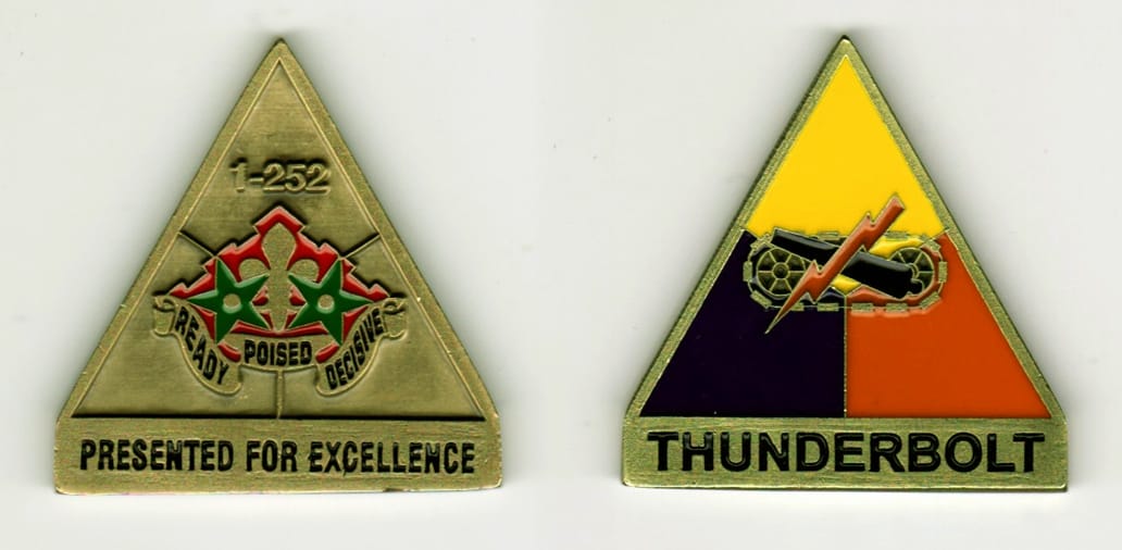 Triangular shaped, brass colored coin, 1 3/4 inches wide x 1 3/4  inches high.