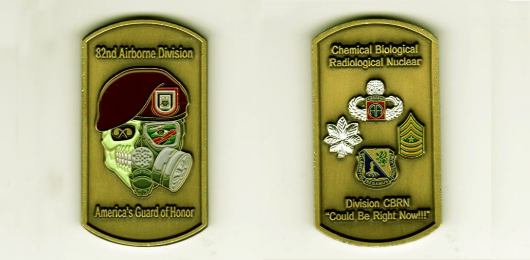 Dog tag shaped, brass colored coin, 1 1/4 inches wide x 2 1/4  inches high.