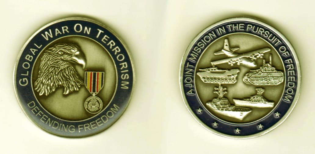 Round shaped, silver colored coin, 1 11/16  inches in diameter.