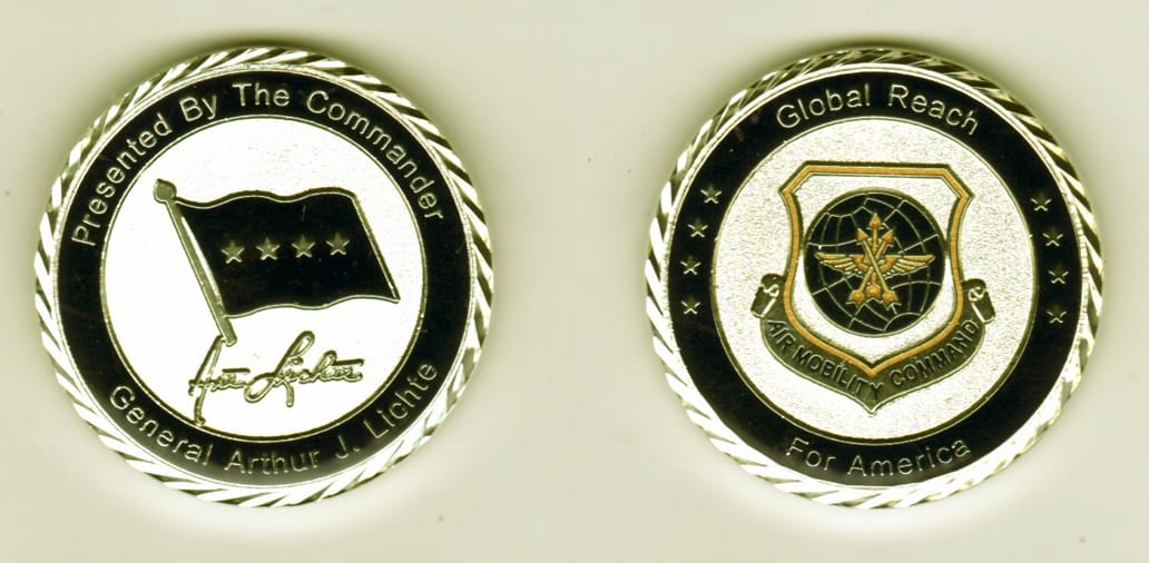 Round shaped, silver colored coin, 1 11/16  inches in diameter.