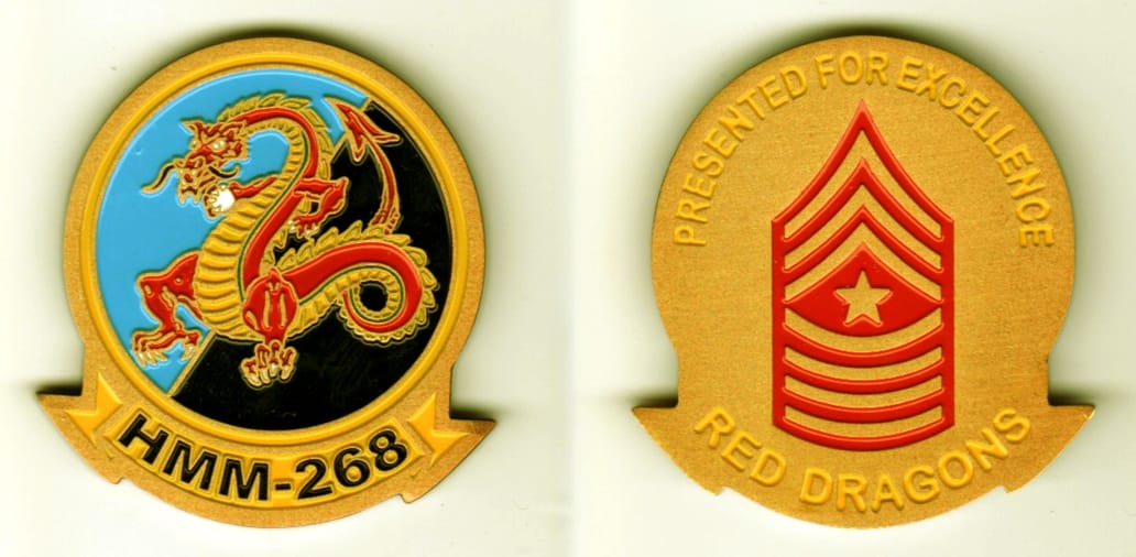 Round shaped, gold colored coin with banner mounted beneath, 1 1/2  inches in diameter.