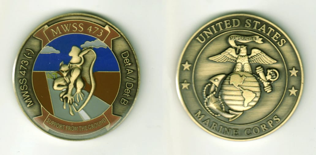 Round shaped, brass colored coin, 1 11/16  inches in diameter.