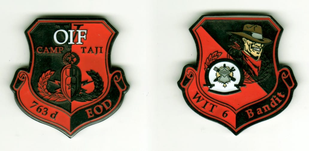 Shield shaped with banner mounted beneath, black and red colored coin, 1 3/4  inches high x 1 3/4 inches wide.