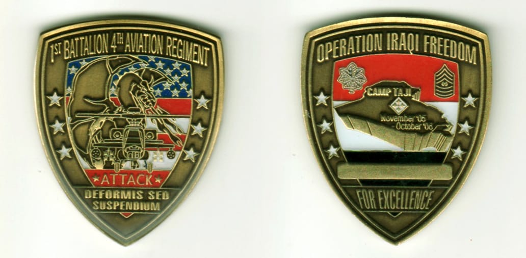 Shield shaped, brass colored coin, 1 11/16  inches in diameter.