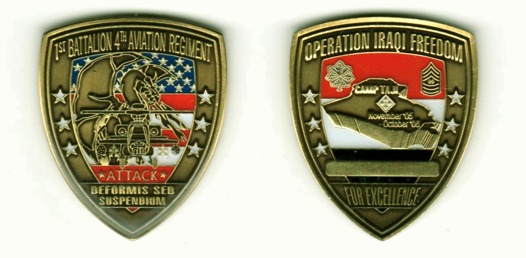 Shield shaped, brass colored coin, 1 11/16  inches in diameter.