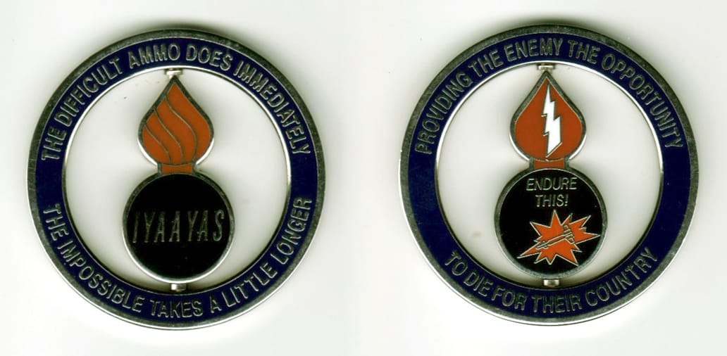 Round shaped, silver colored coin, 1 11/16  inches in diameter. Ordanance symbol in center rotates.