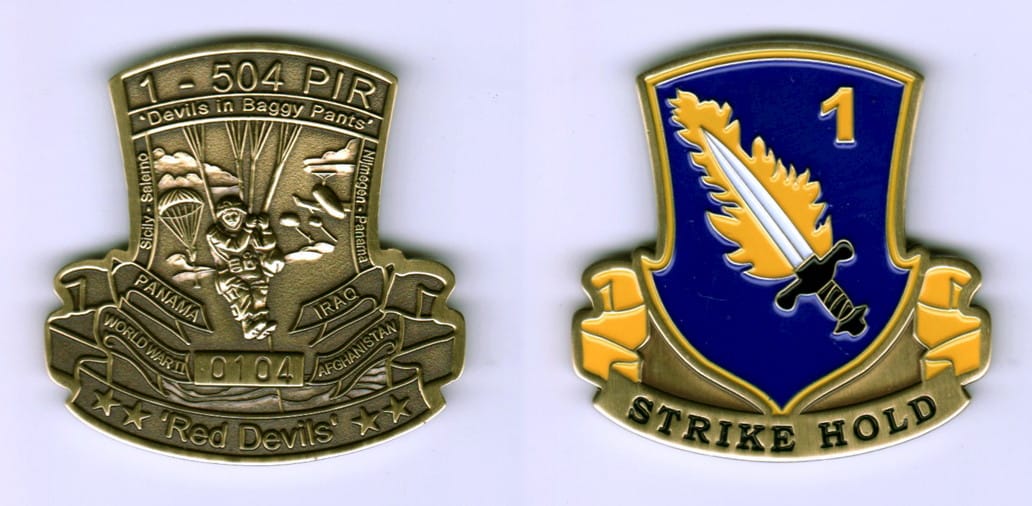 Shield shaped with banner mounted beneath, brass colored coin, 1 7/8 inches high x 1 7/8 inches wide